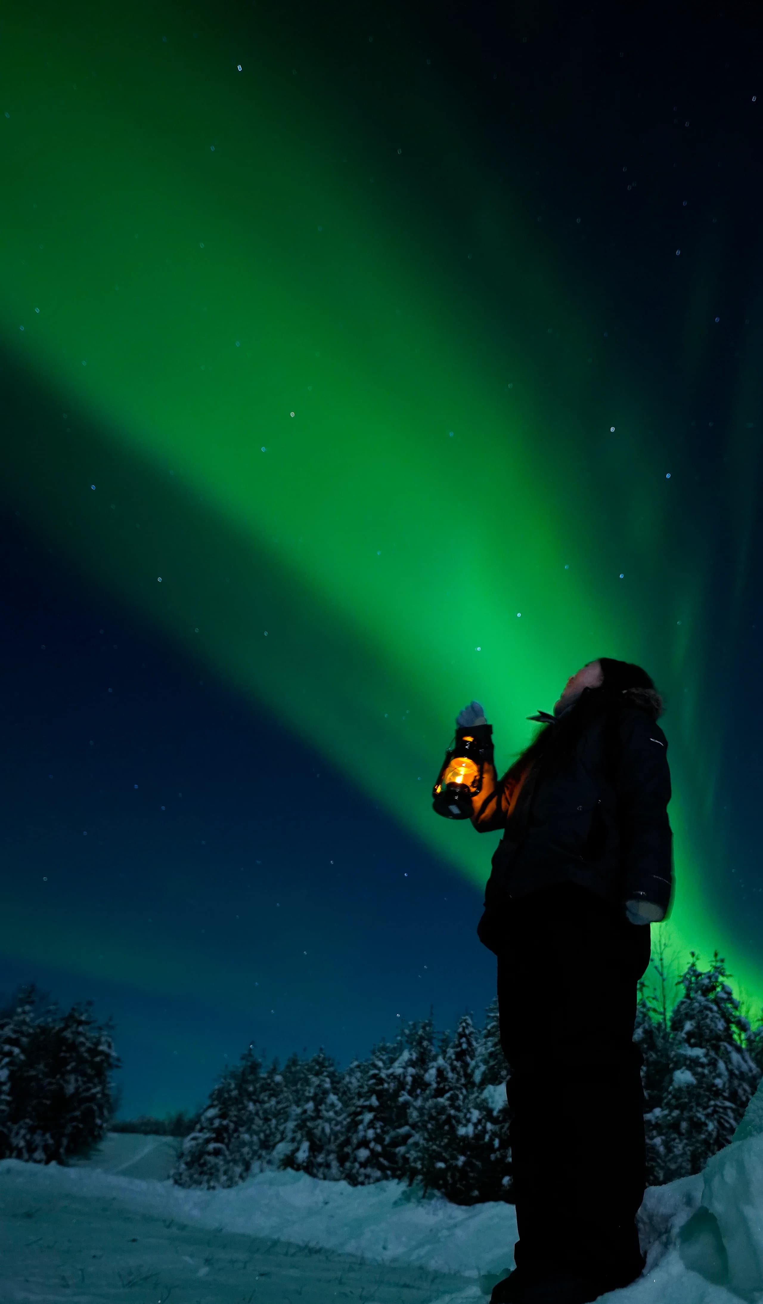 Aurora rising above the snowy fells