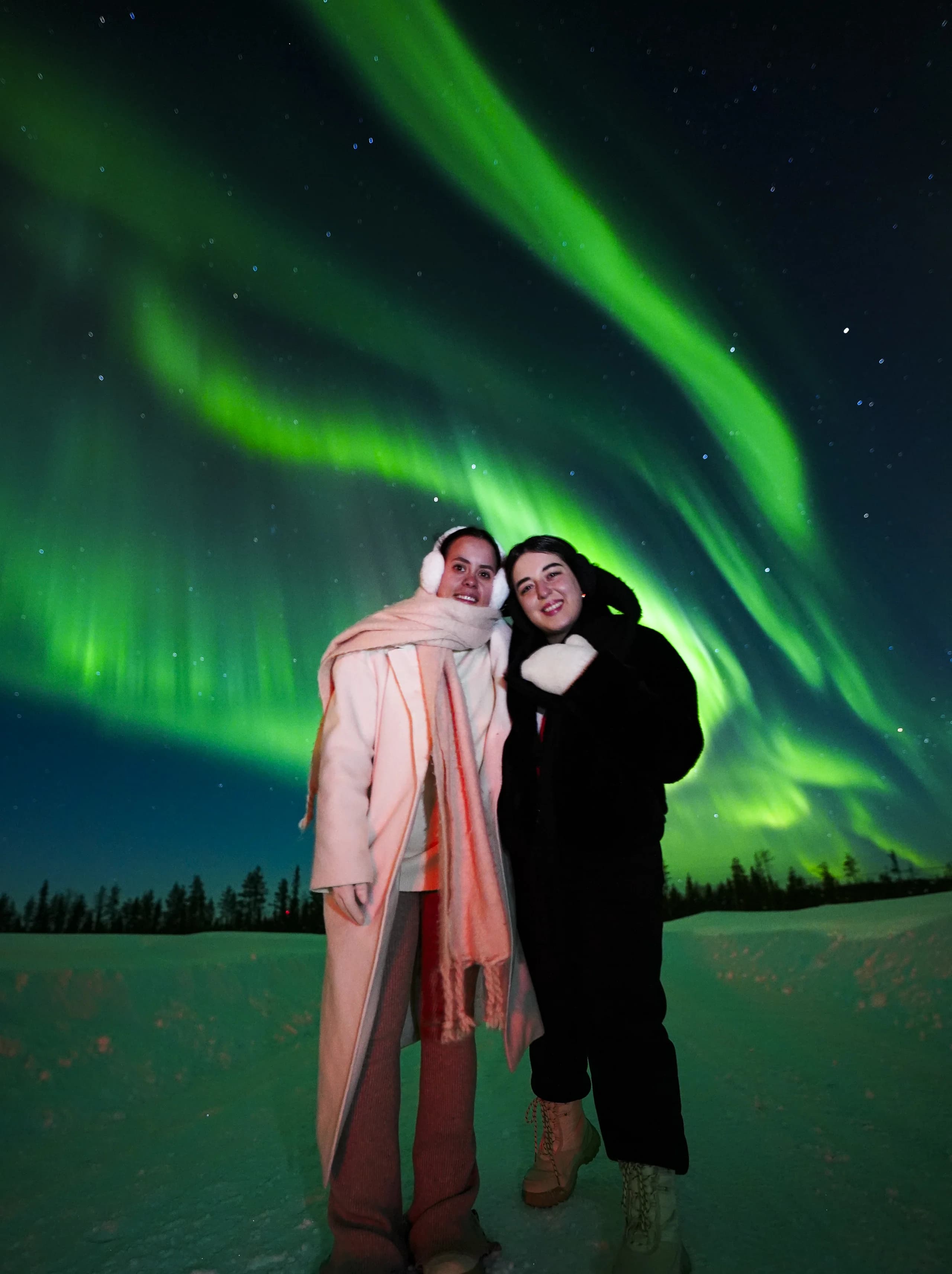 Northern Lights glowing above the Lapland sky